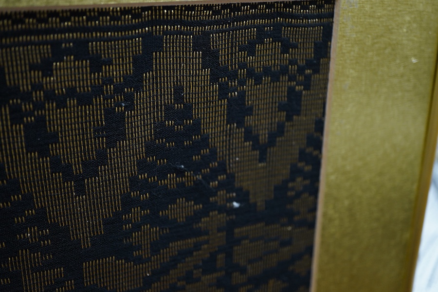 A framed 20th century black and gold brocade sample, possibly Thai 37cm x 97cm.